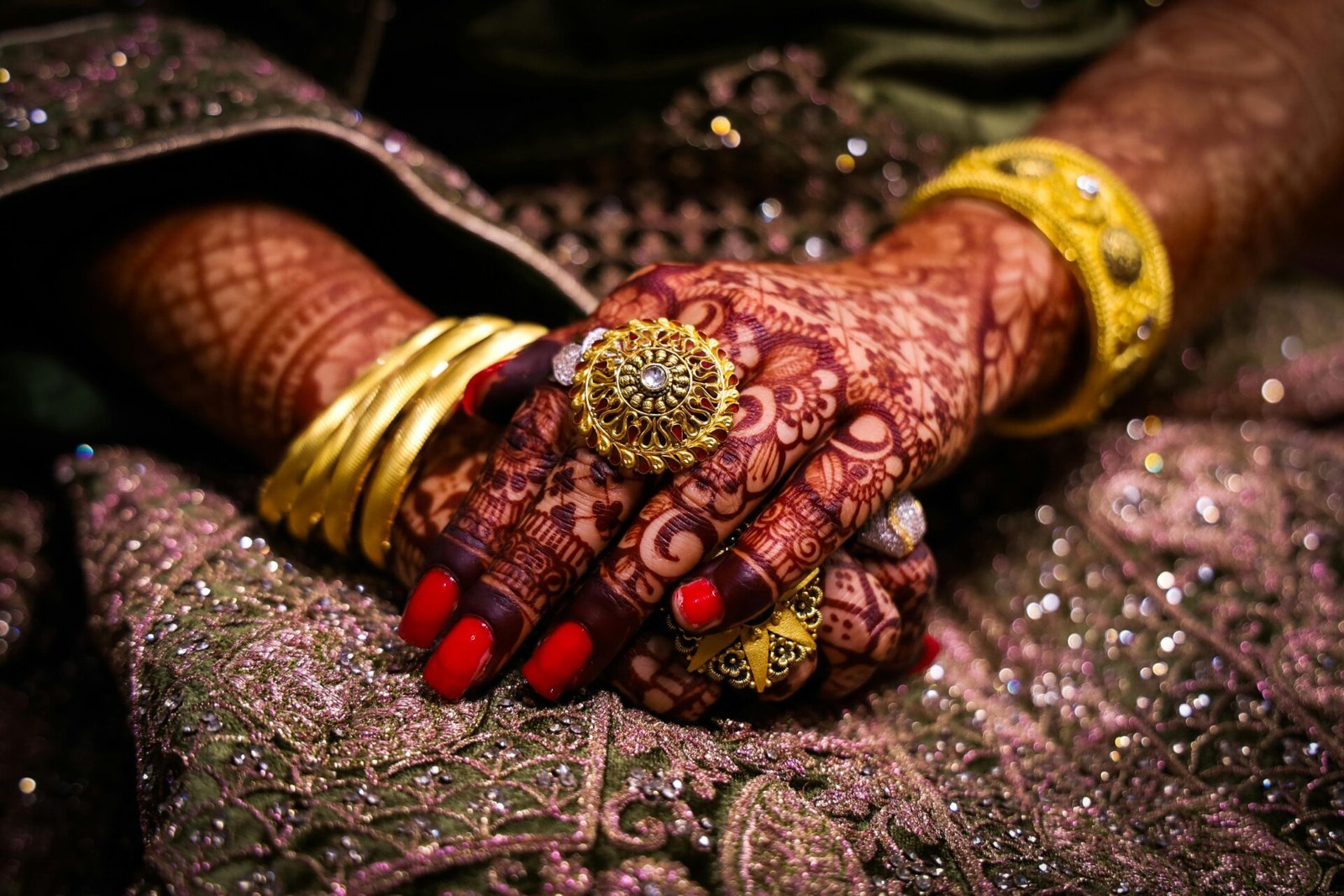 Close-Up Photo of a Person's Hand with a Ring and Mehndi